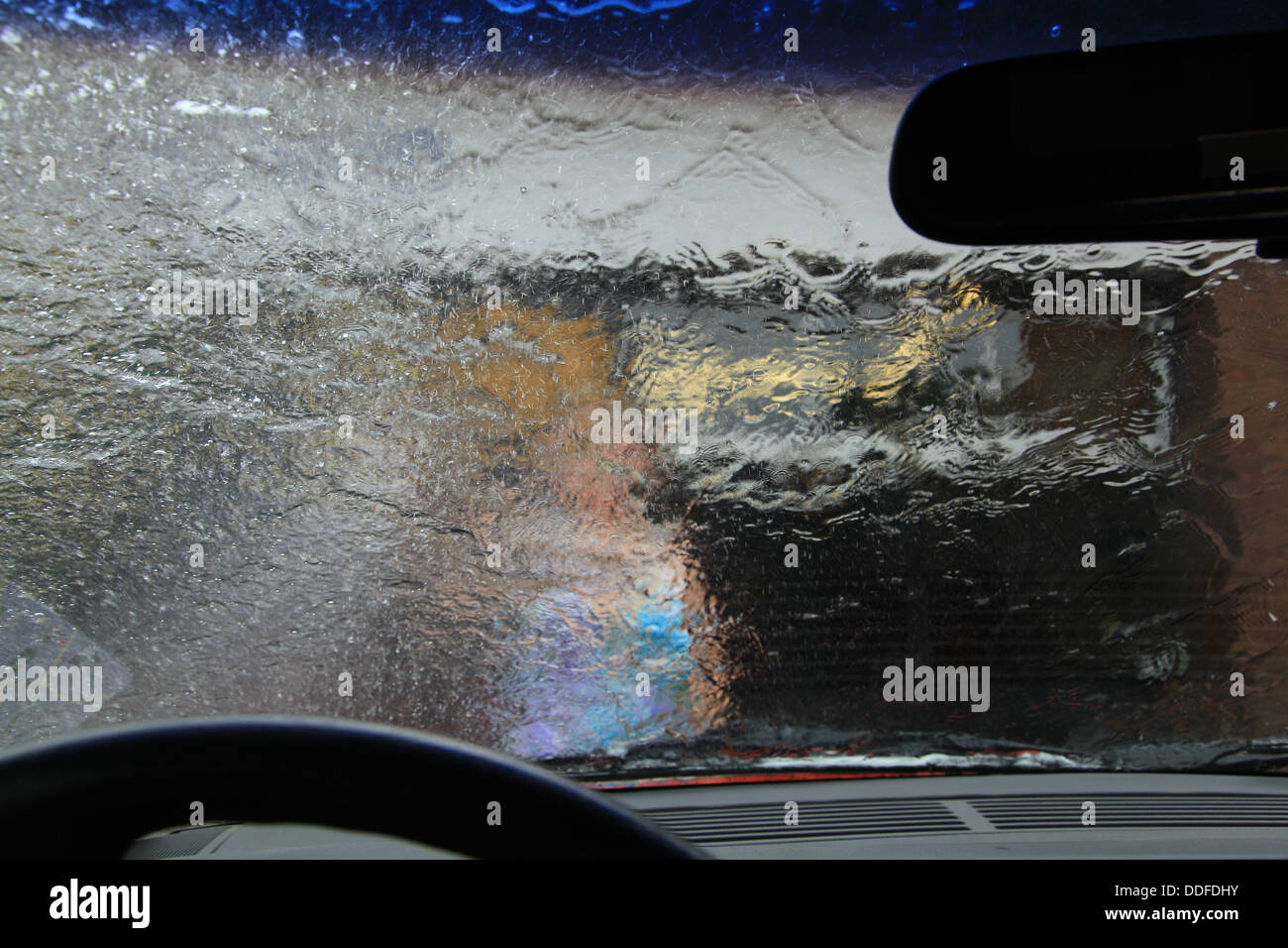 Soap suds on car window in car wash, view from inside Stock Photo