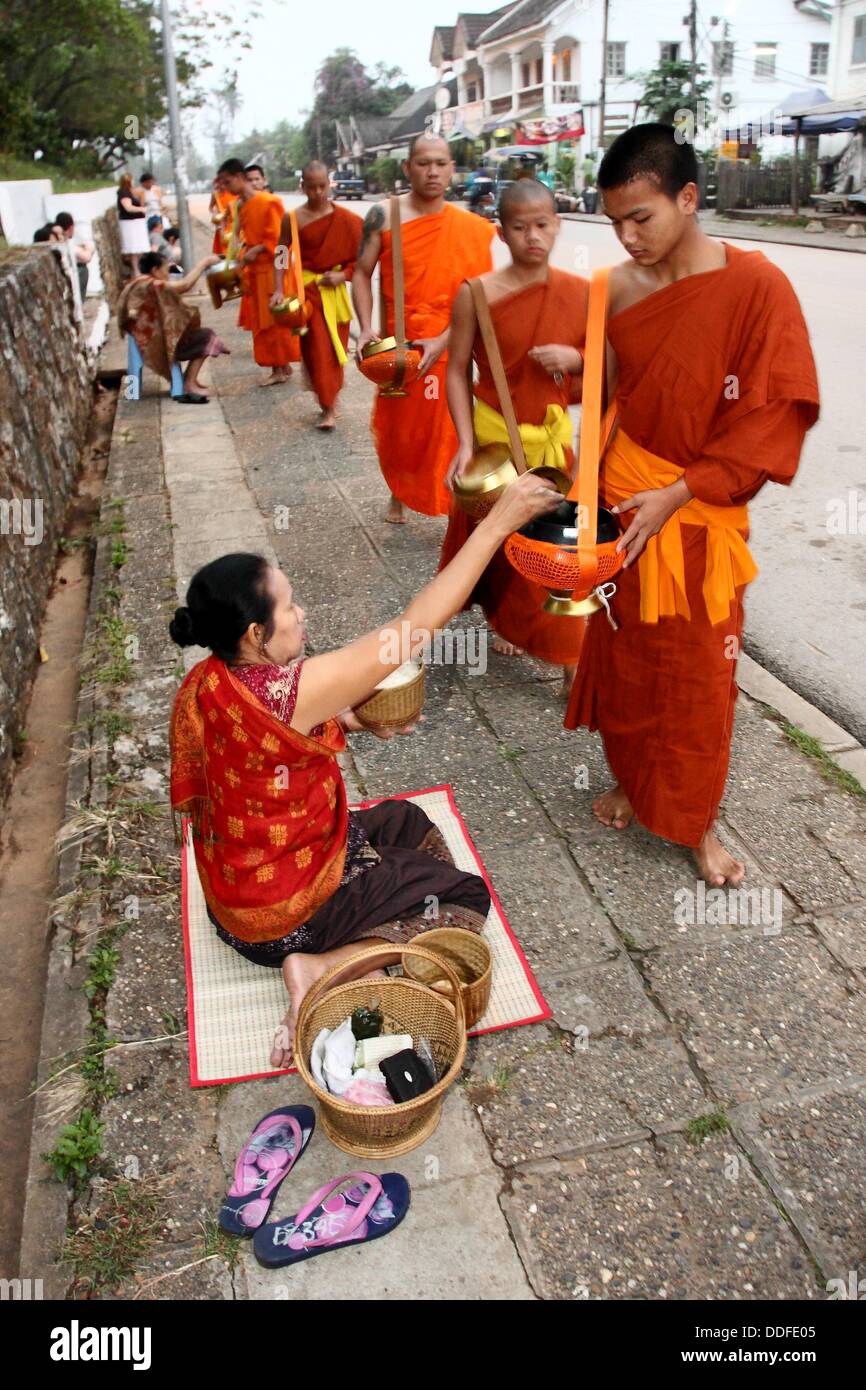 Morning round of buddhist monks begging for alms or Tak Bat, Luang Prabang,  UNESCO World Heritage Site, Laos Stock Photo - Alamy