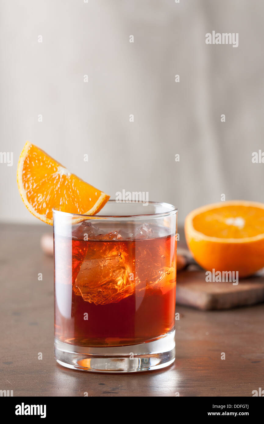 Classic negroni cocktail with an orange slice on wooden table Stock Photo