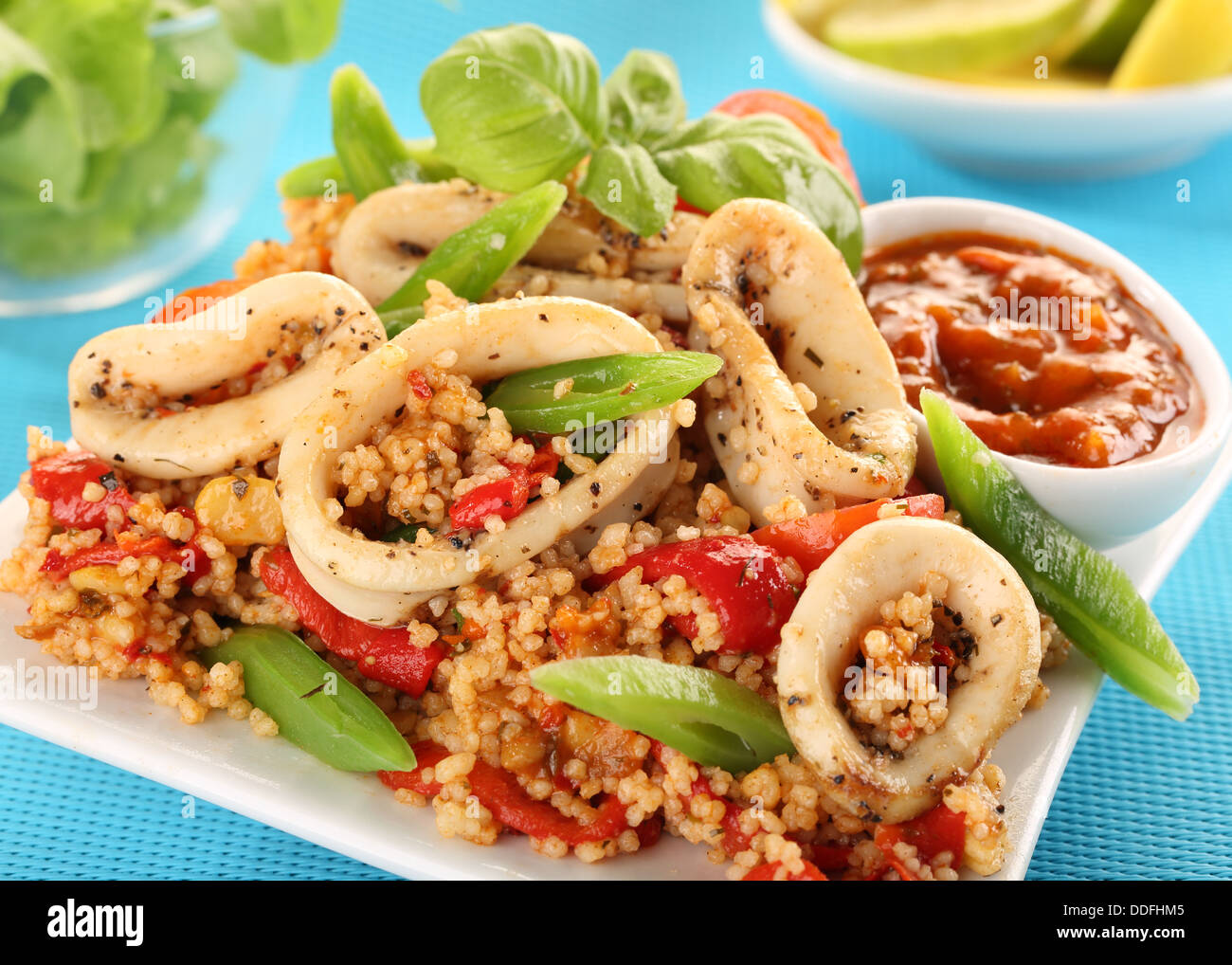 SQUID OR CALAMARI AND COUSCOUS SALAD WITH PEPPERS AND GREEN BEANS Stock Photo