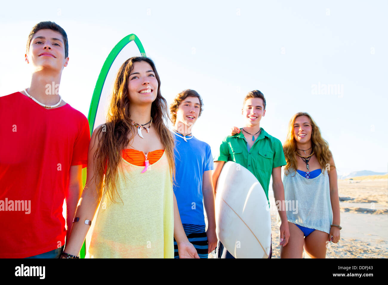 Teenager surfers boys and girls group happy in beach shore high key