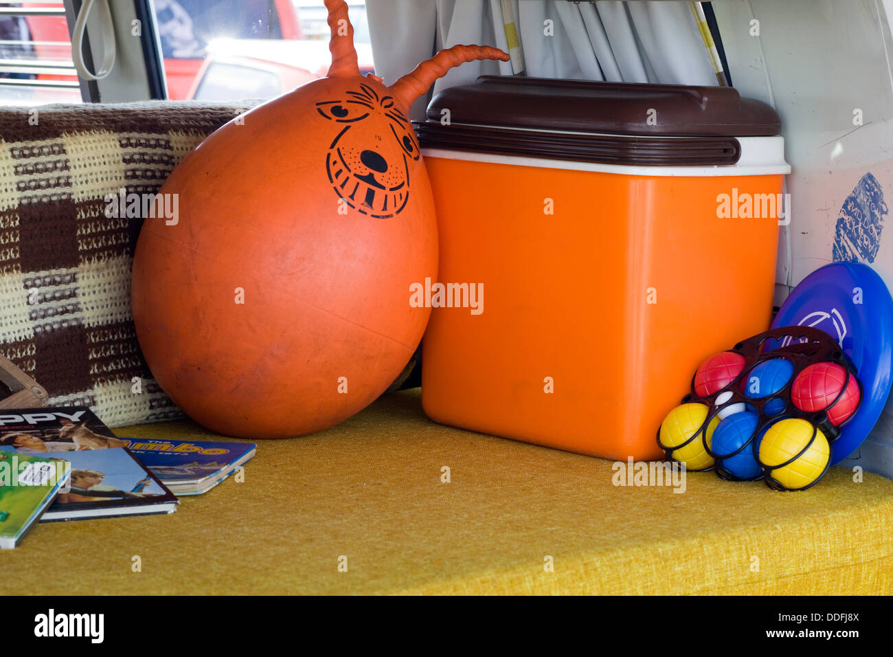Space hooper Cool box plastic Balls and a Frisbee in the back of a  Volkswagen Camper van Stock Photo