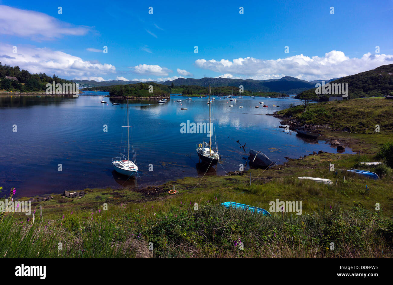 Small boats in bay, blue sea and sky, Gairloch, Northwest Scotland Stock Photo