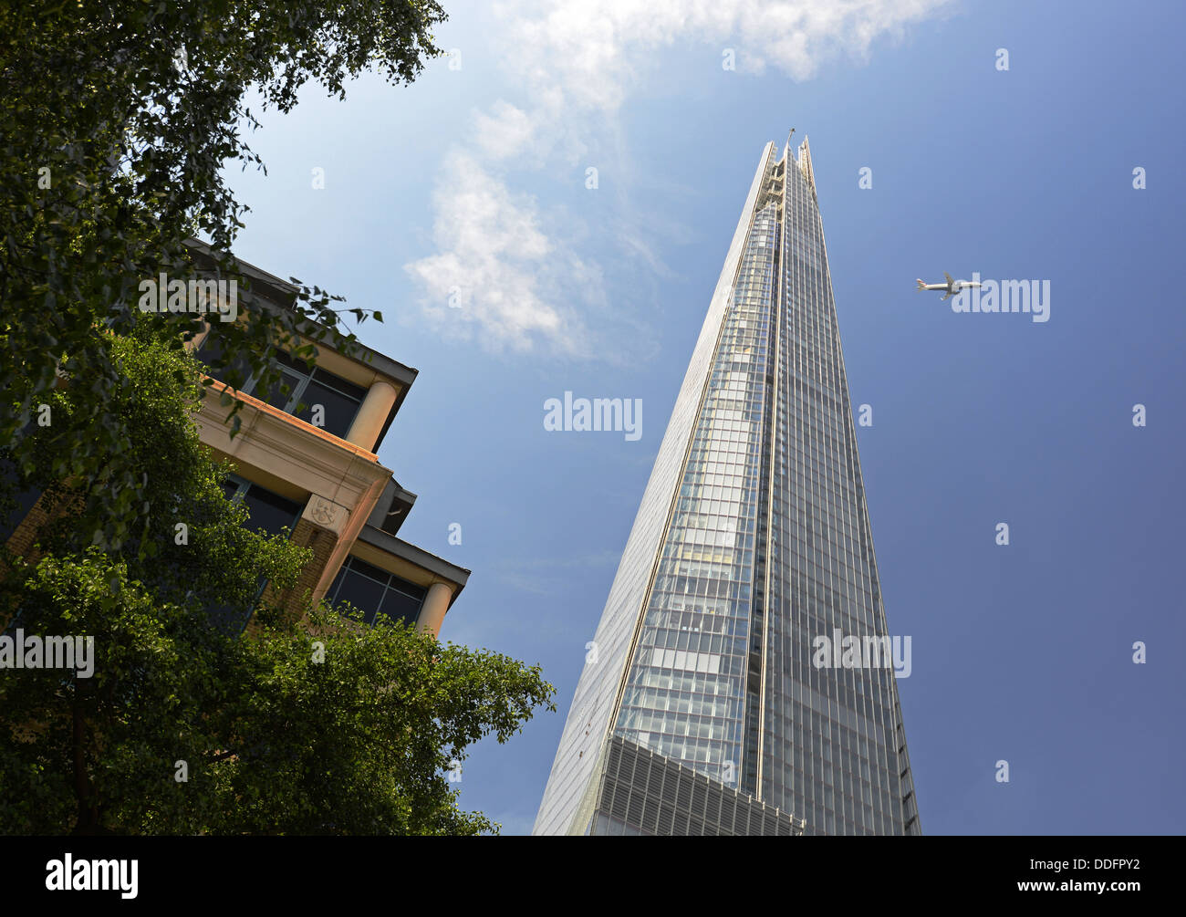 The Shard skyscraper building and airplane, Southwark, London, England, UK Stock Photo