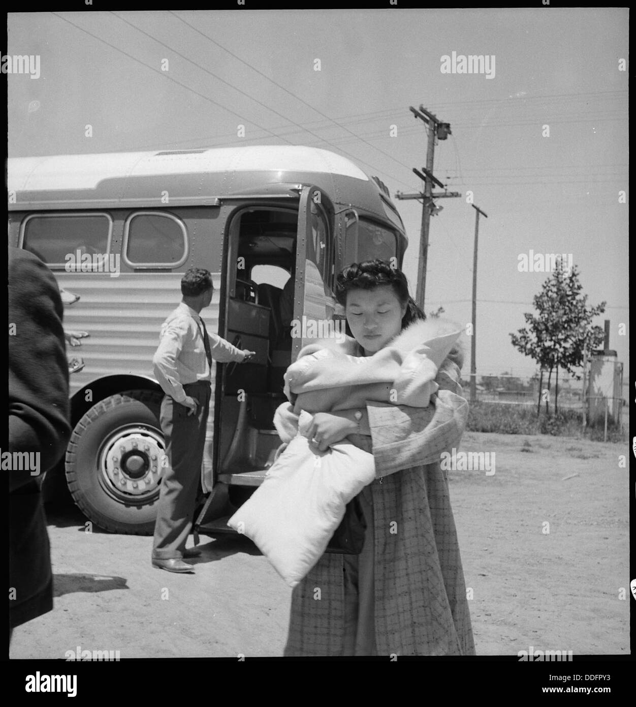 Stockton, California. Young mother of Japanese ancestry arrives at Assembly center with 21 day old baby. 537719 Stock Photo