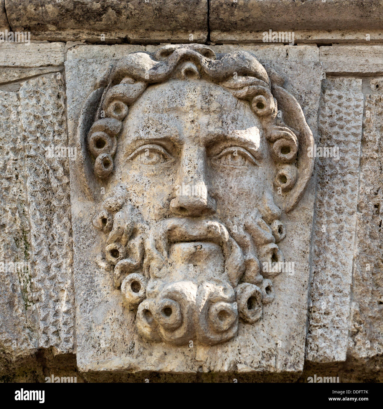 sculpture in stone face with a beard close-up Stock Photo