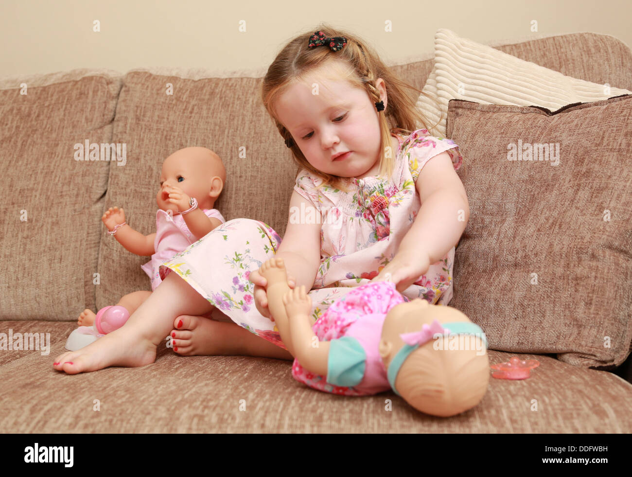 Little girl playing with dolls Stock Photo
