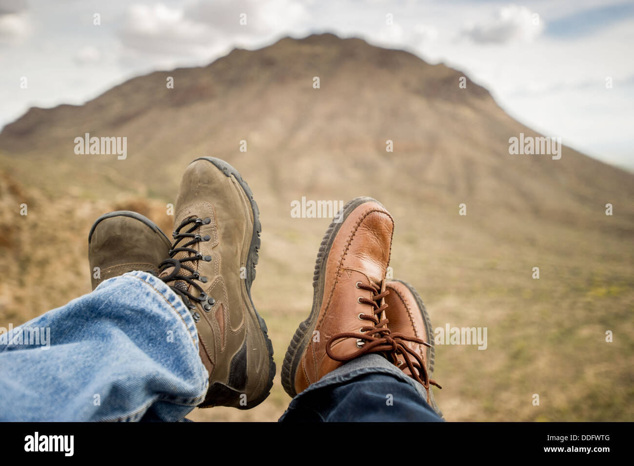 Man and woman feet with hiking boots at base of mountain, Tucson AZ Stock Photo