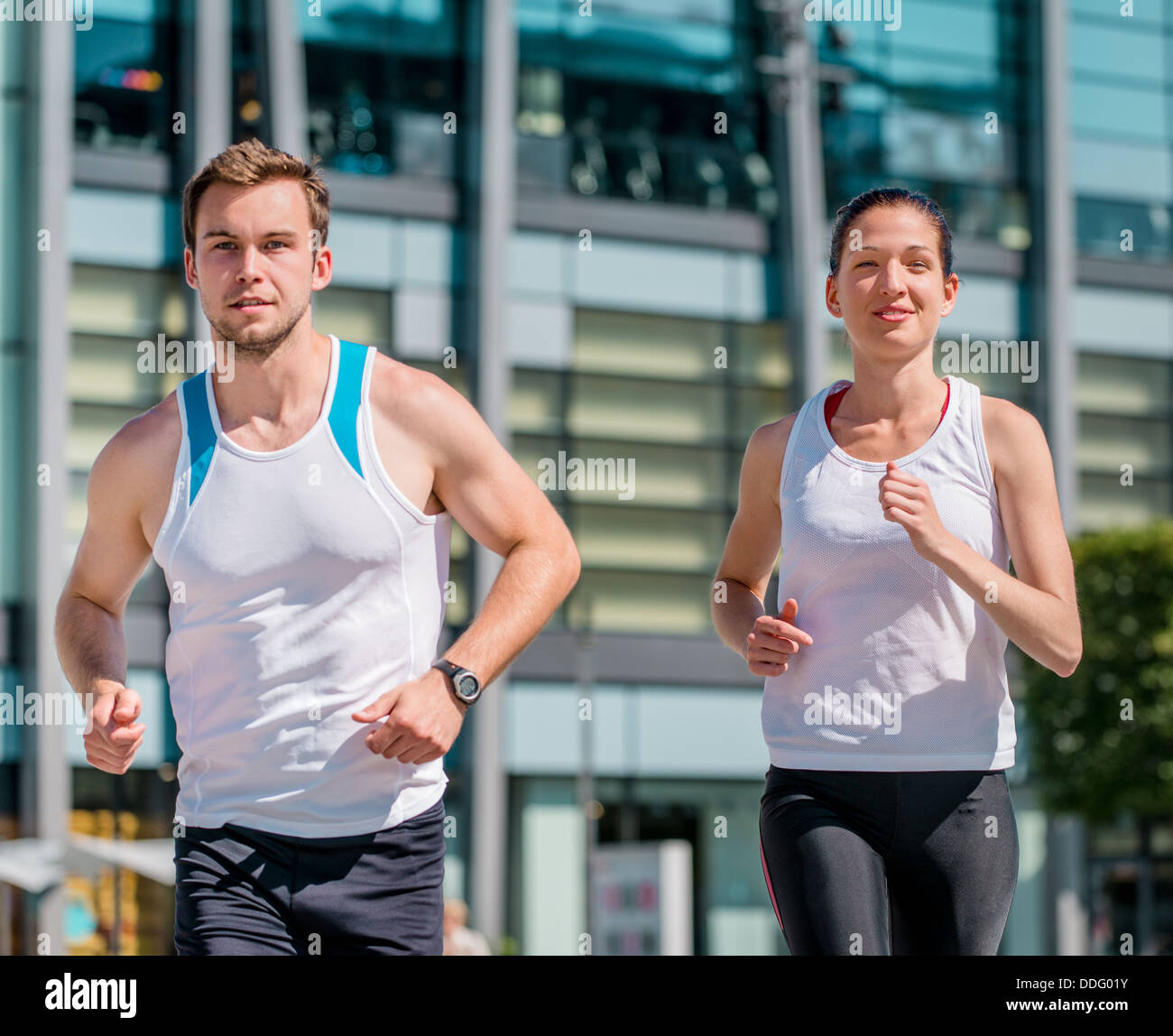 Young sport couple jogging together in city environment Stock Photo