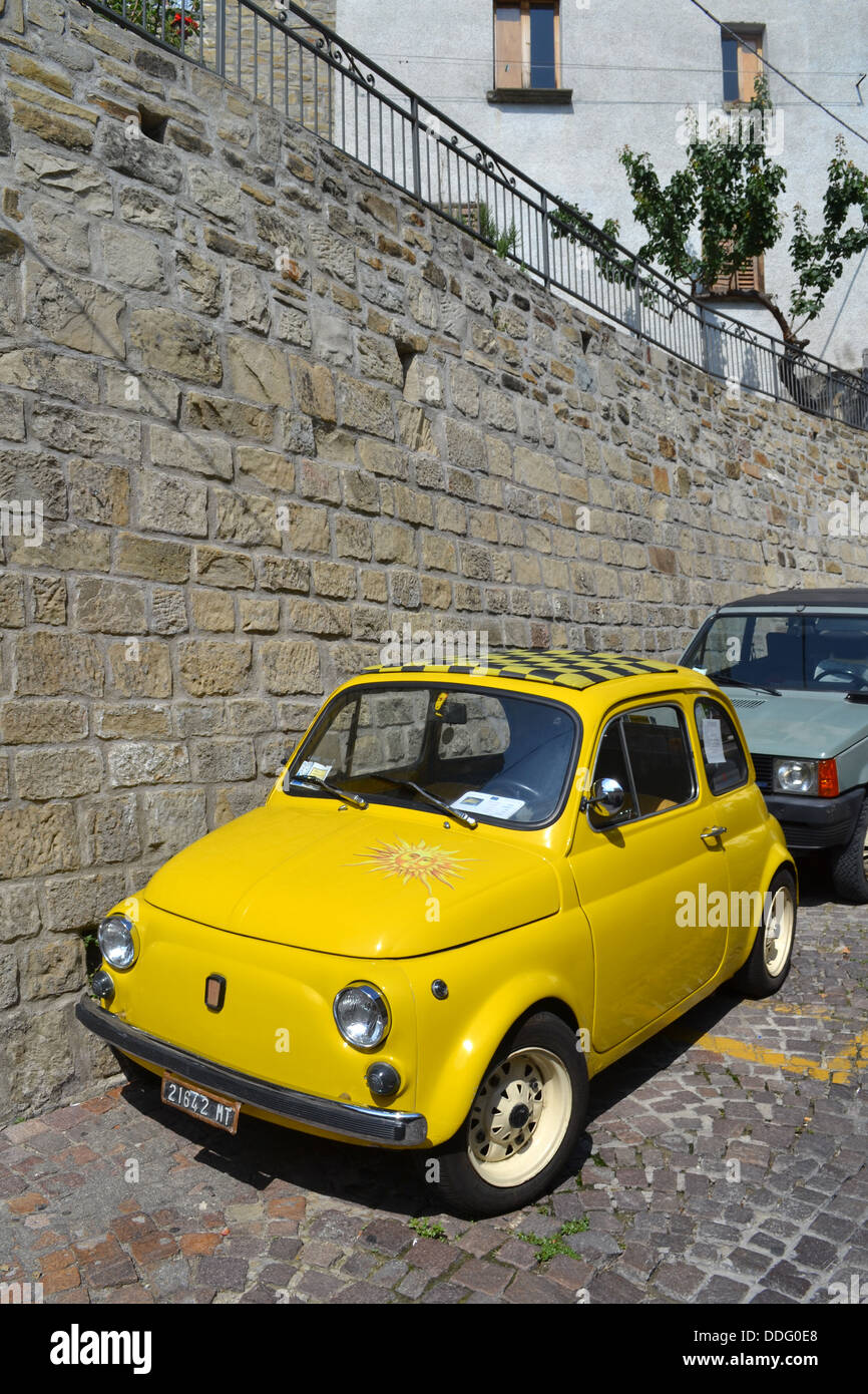 Car yellow Cinquecento / fiat 500, Pietrapertosa village, Basilicata, South Italy. Dolomites mountain range. Stock Photo