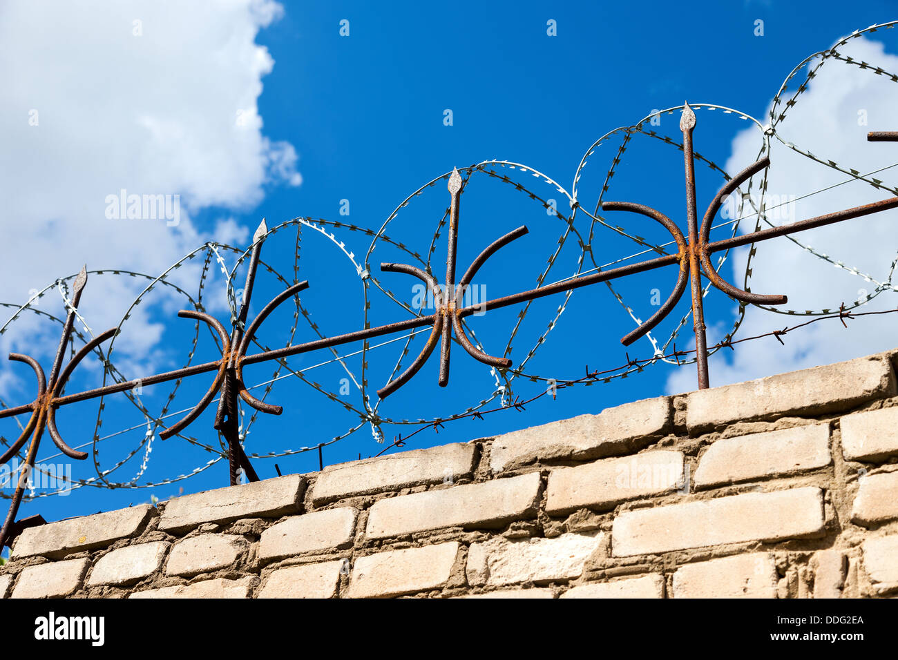 Barbed wire on blue sky background Stock Photo - Alamy