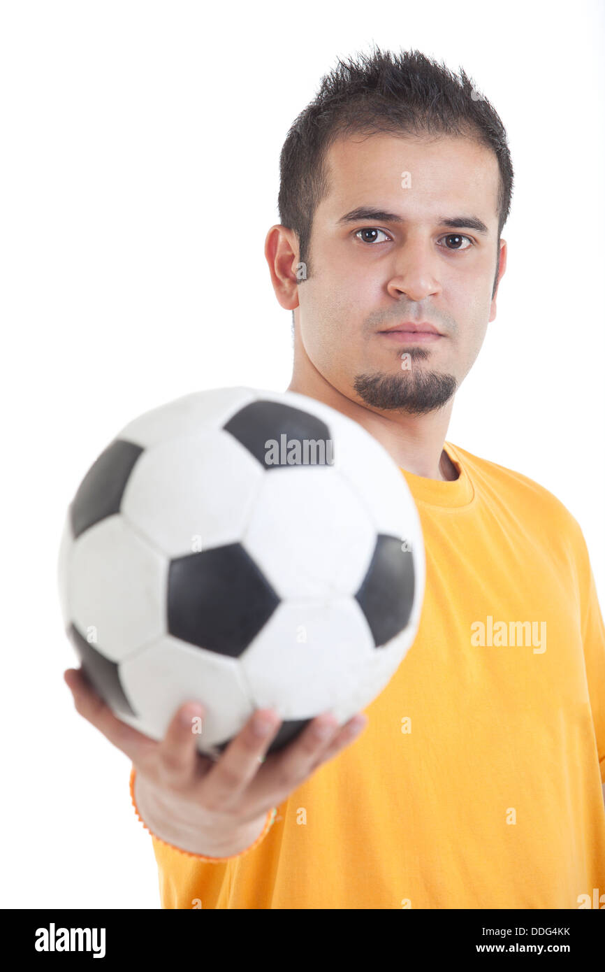 Portrait of young man holding soccer ball over white background Stock ...