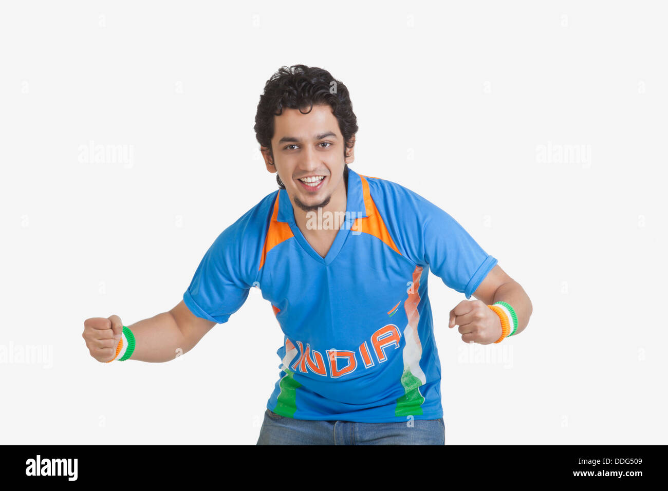 Portrait of young man in Indian cricket team jersey cheering with clenched  fists over white background Stock Photo - Alamy