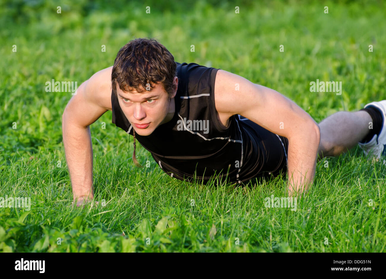 Handsome man doing push-ups at the park Stock Photo - Alamy