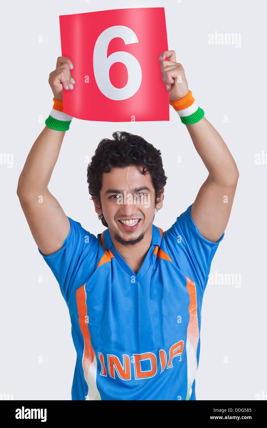 Portrait of young man in Indian cricket team jersey signaling a six over  white background Stock Photo - Alamy
