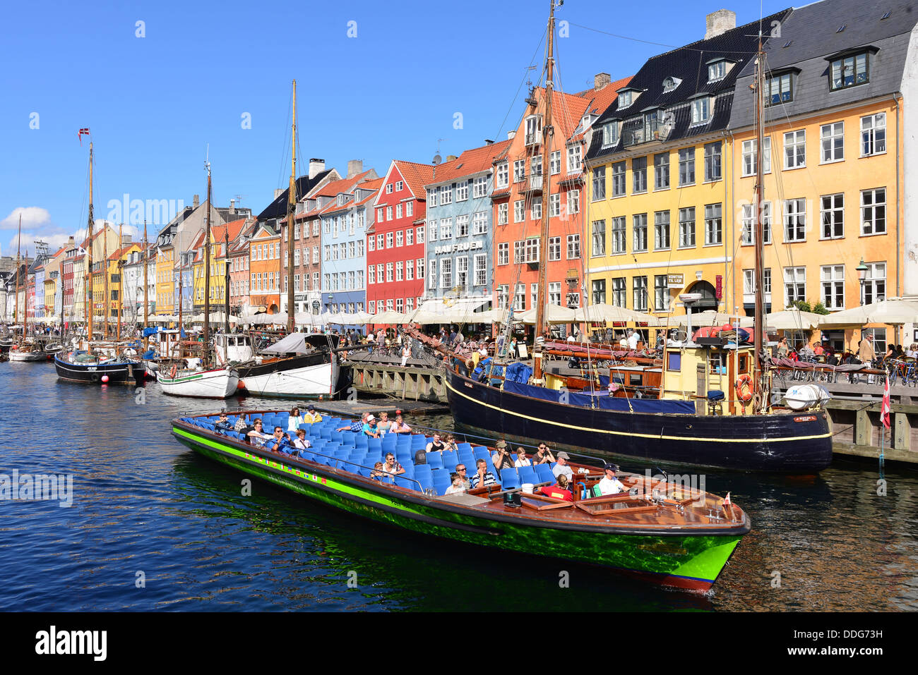 Nyhavn Copenhagen on a summer's day with tourists taking a boat trip Stock Photo