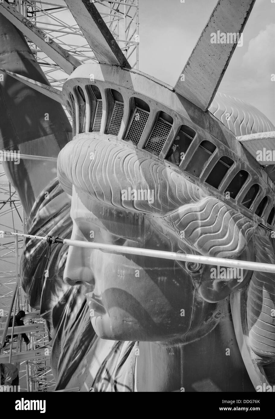 Close up of the head and crown of the Statue of Liberty hidden behind