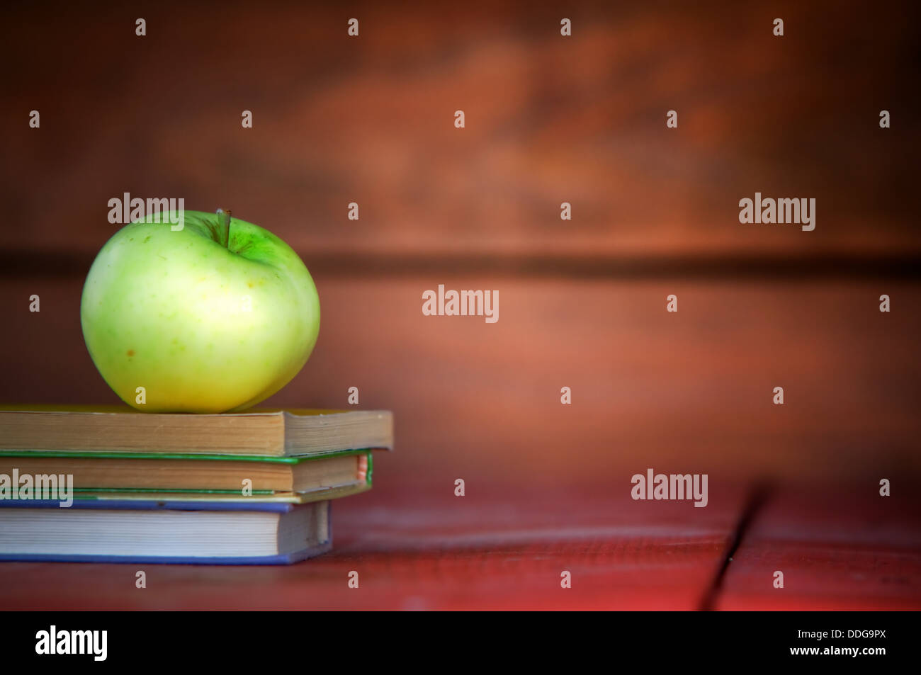 Concept education - Apple for the teacher on pile of books. Learning, back to school concepts. Stock Photo