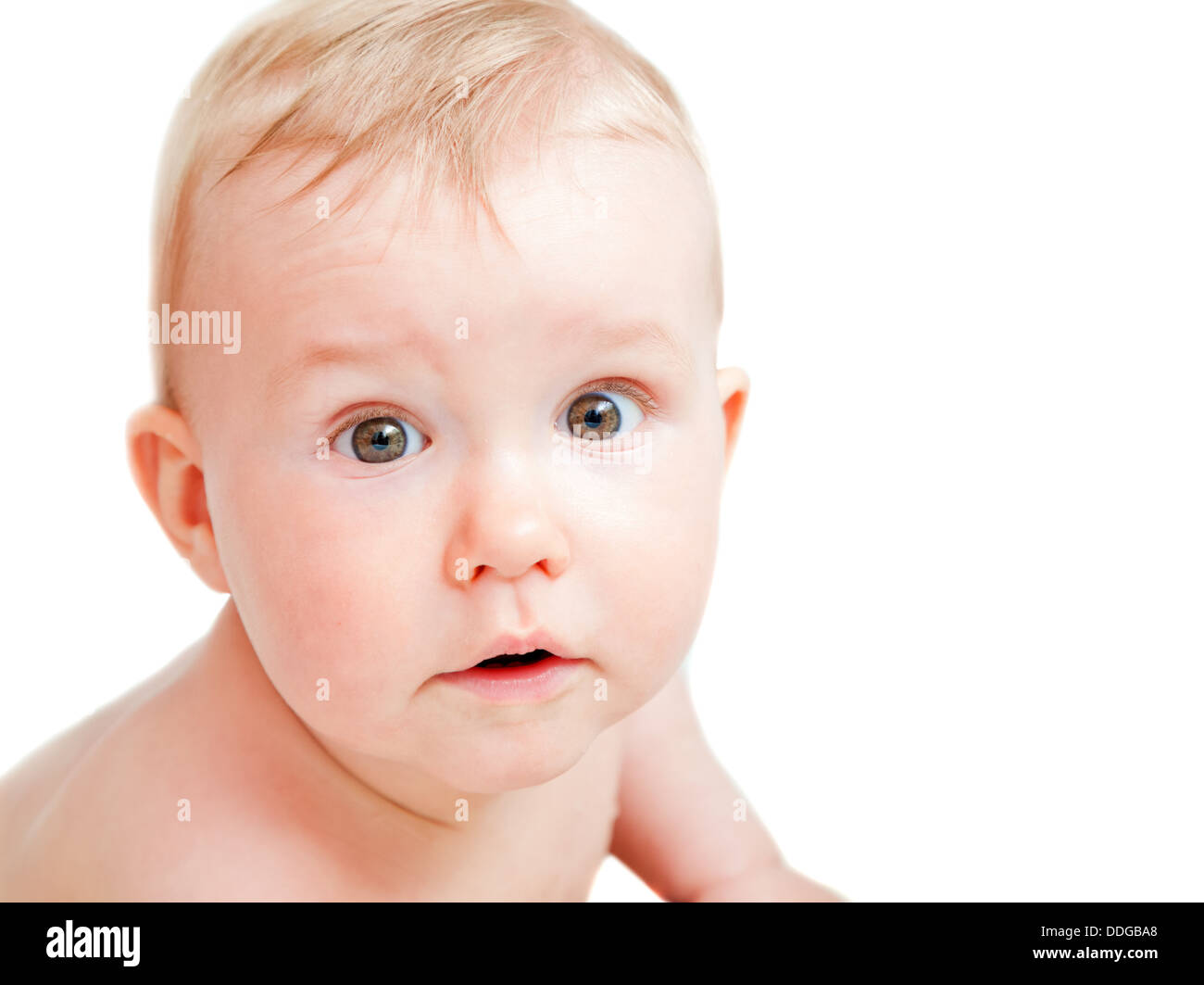 Cute baby with surprised face expression looking at the camera Stock Photo