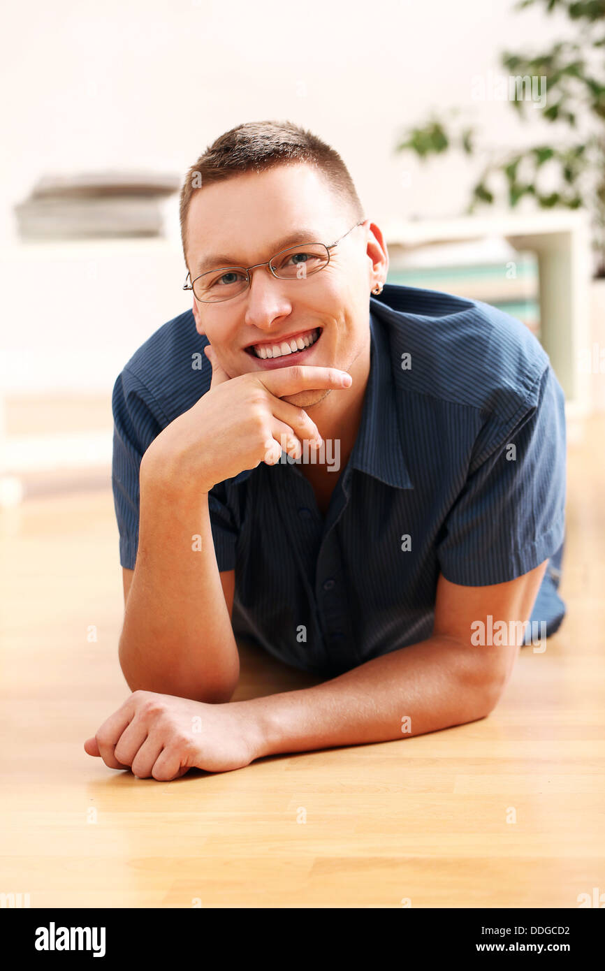 Portrait of lying young man in glasses Stock Photo - Alamy