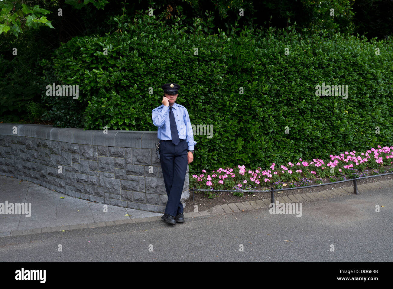 A Garda on the phone in St Stephens Green, Dublin, Ireland Stock Photo
