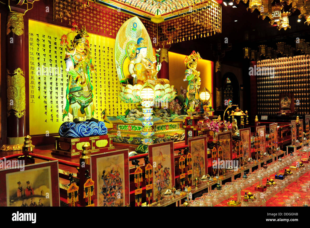 A beautifully handcrafted Bodhisattva Avalokitesvara sits upon an elaborate lotus throne  (The Buddha Tooth Relic Temple) Stock Photo