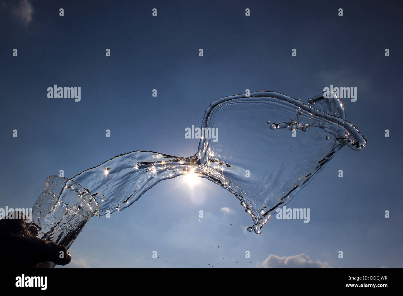 Water splashing from pint glass Stock Photo