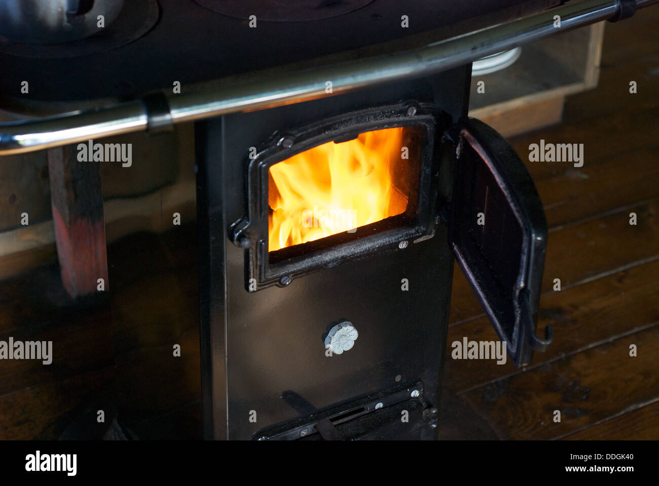 A wood burning stove with bright yellow flames Stock Photo Alamy