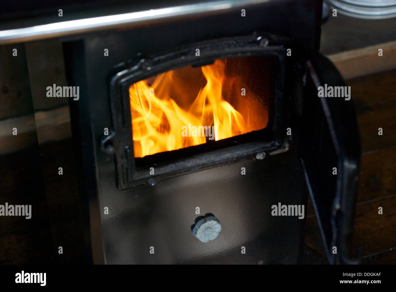 A wood burning stove with bright yellow flames Stock Photo Alamy