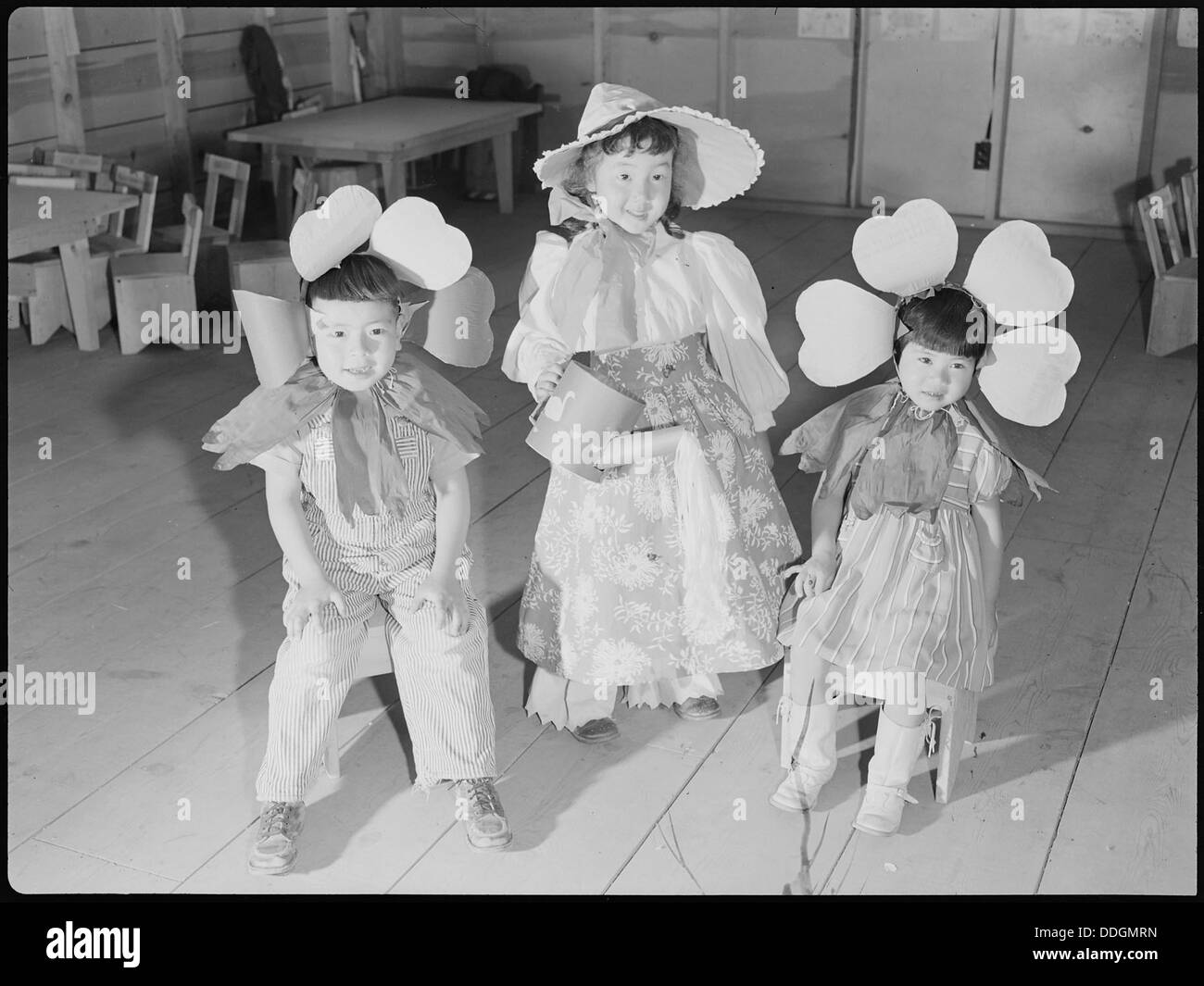 Tule Lake Relocation Center, Newell, California. Nursery school children pause for refreshments of . . . 538344 Stock Photo