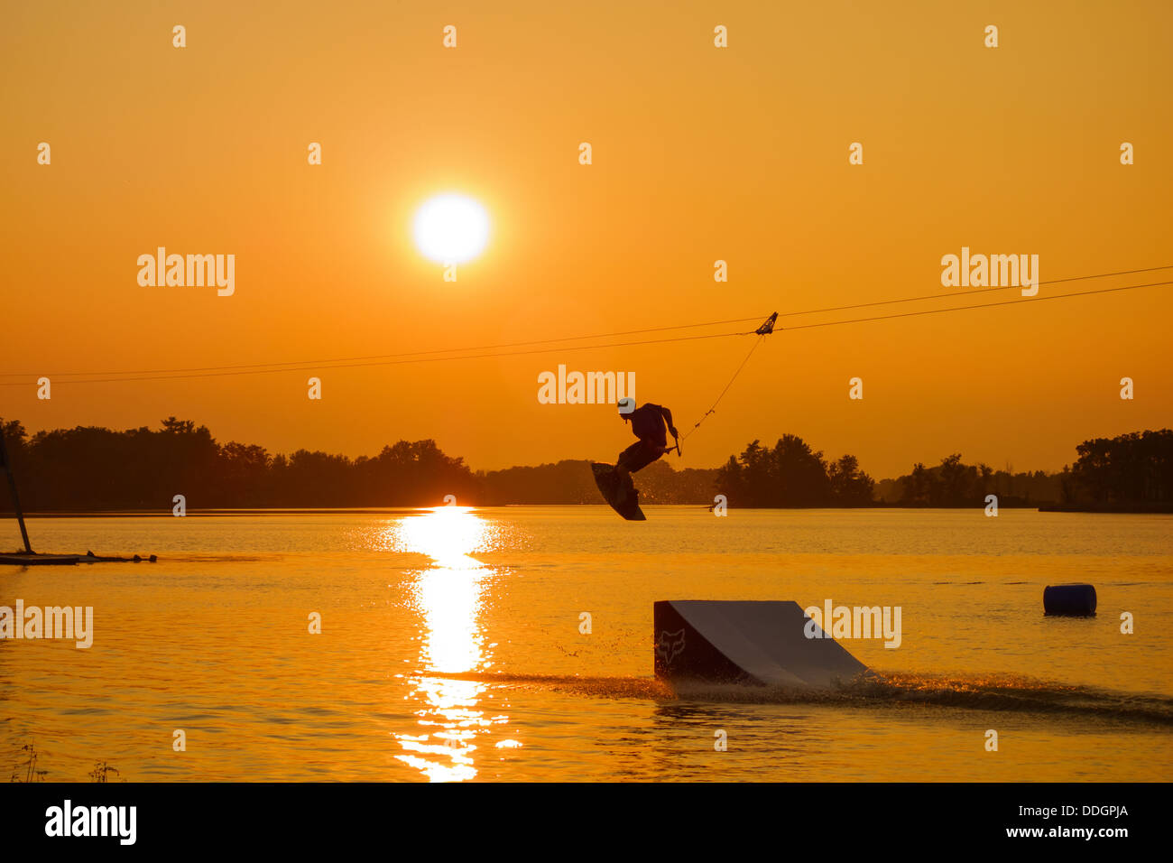 Silhouette of a man cable wakeboarding Stock Photo