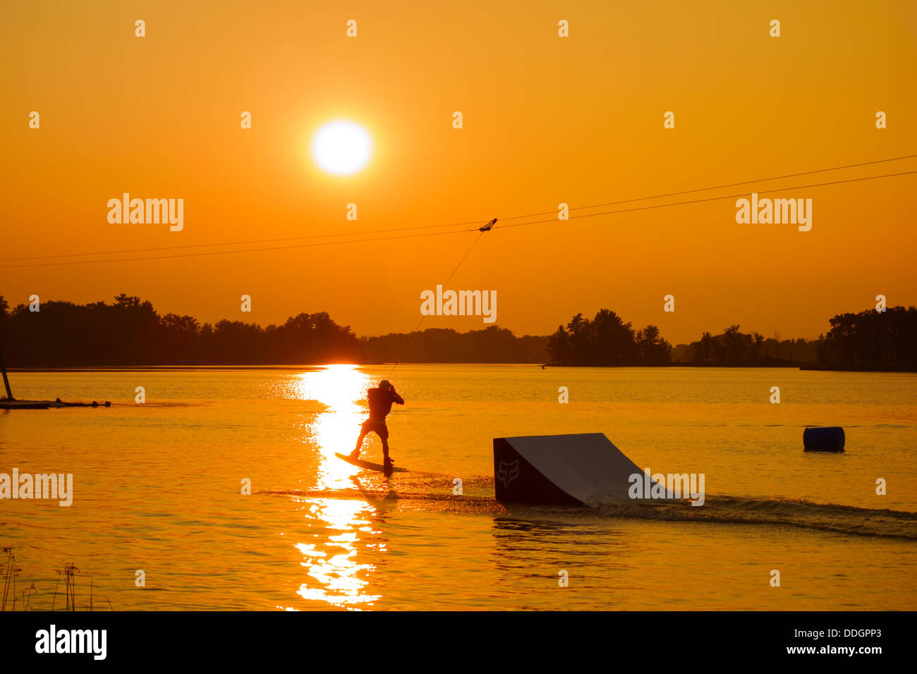 Silhouette of a man cable wakeboarding Stock Photo