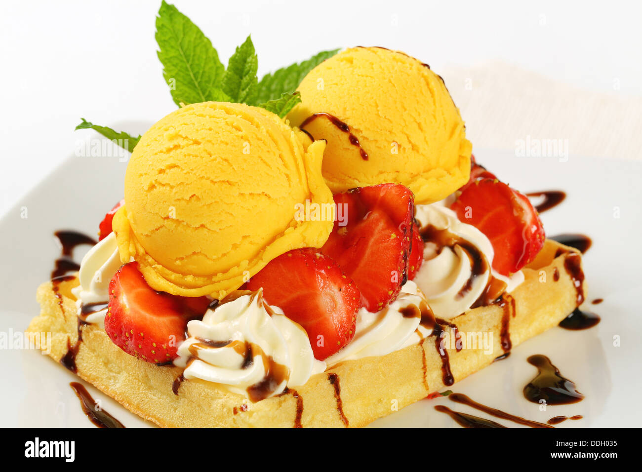 Belgian waffle topped with whipped cream, fresh strawberries and ice ...