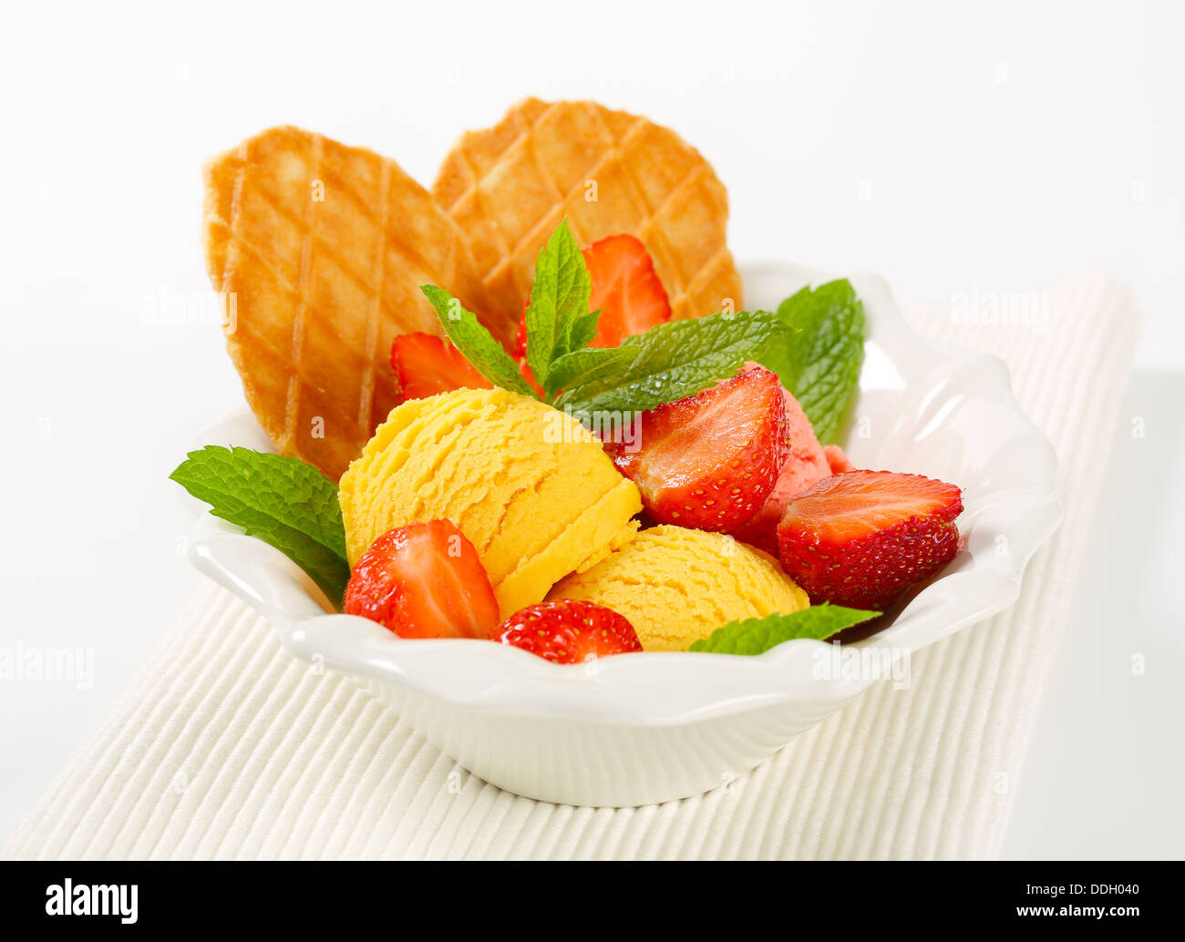 Ice cream with fresh strawberries and thin waffles Stock Photo