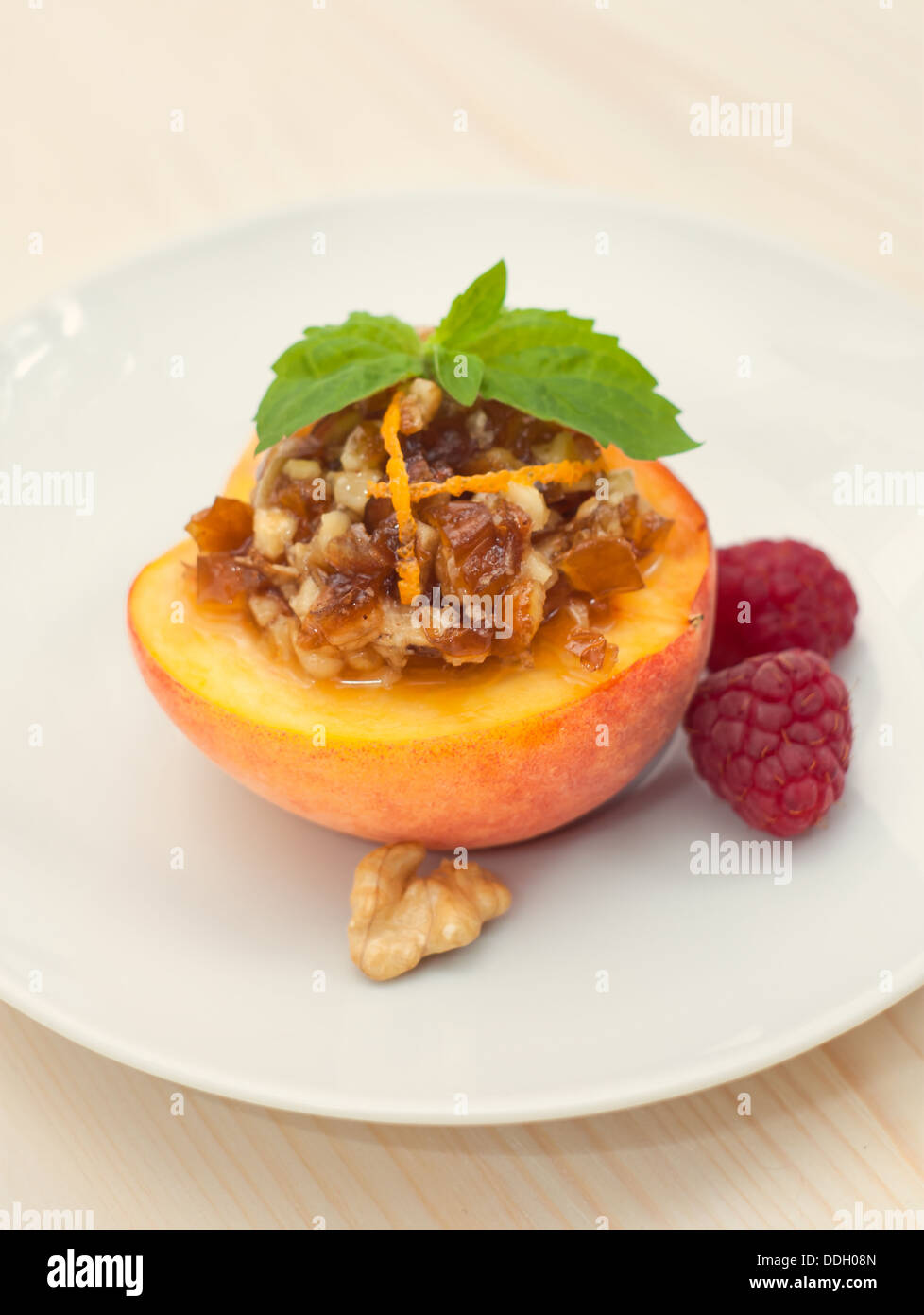 Peach dessert with date and walnut on white plate Stock Photo Alamy