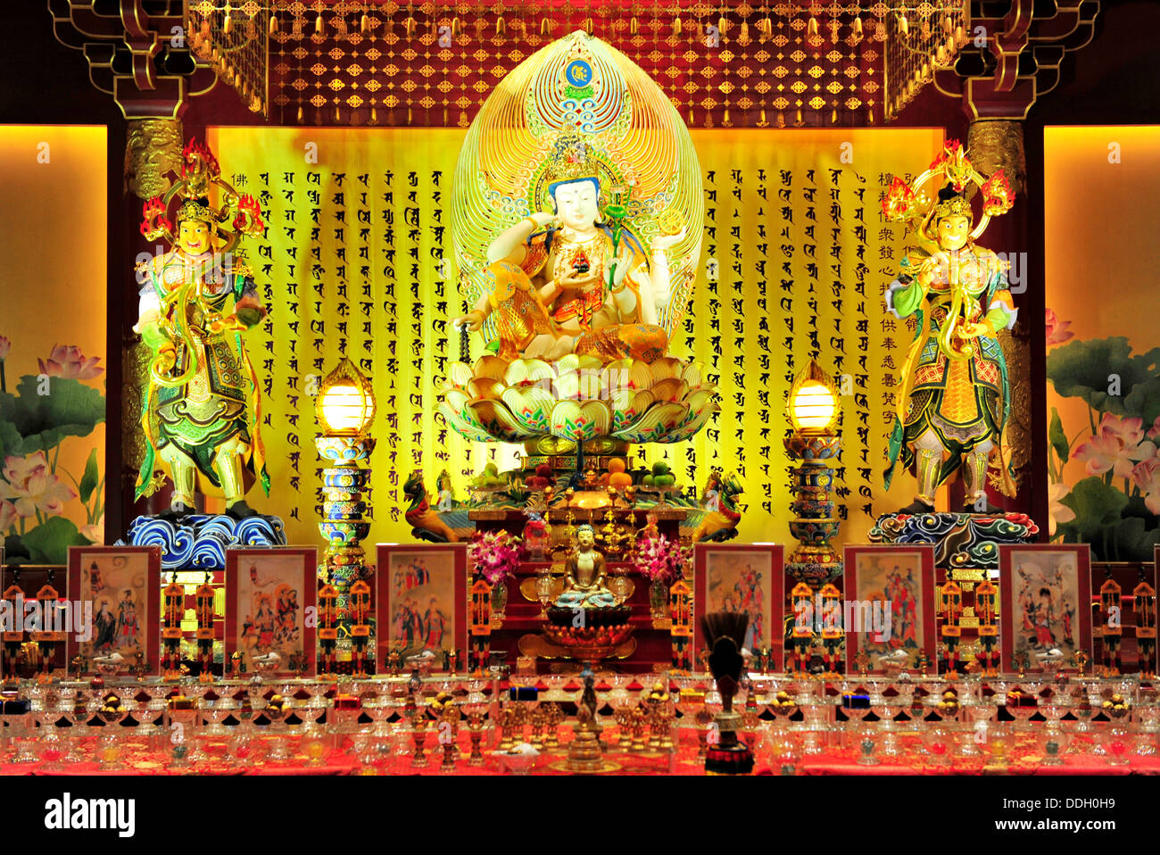 A beautifully handcrafted Bodhisattva Avalokitesvara sits upon an elaborate lotus throne  (The Buddha Tooth Relic Temple) Stock Photo