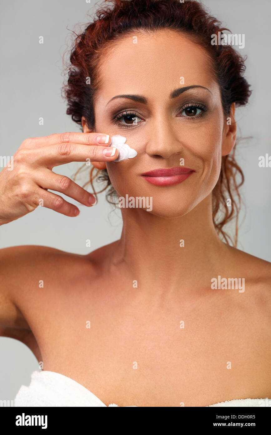 Natural middle aged woman with cream Stock Photo