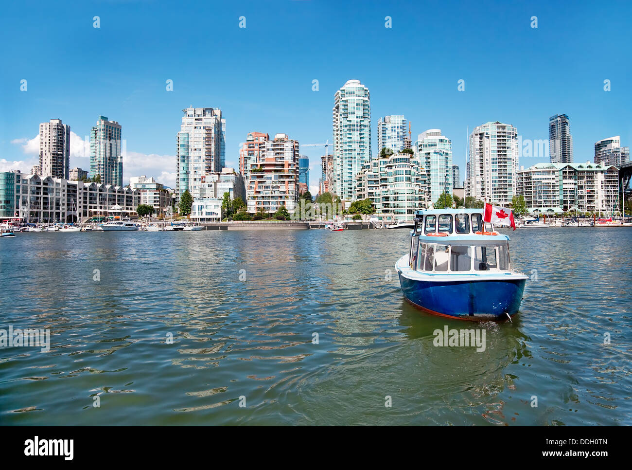 A passenger ferry is commuting between Granville Island and Vancouver downtown. Stock Photo