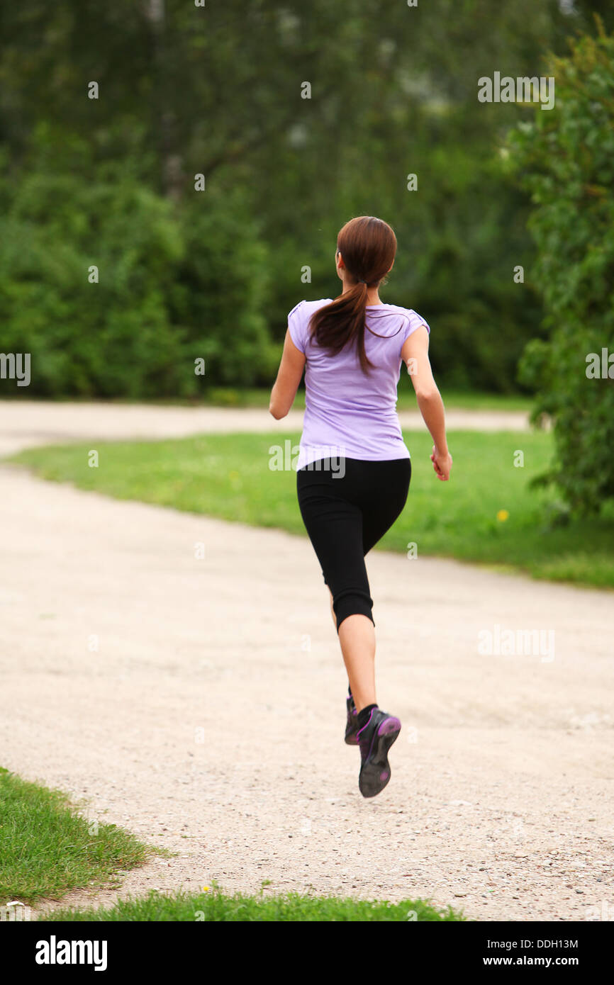 Young and attractive girl running in the park Stock Photo Alamy