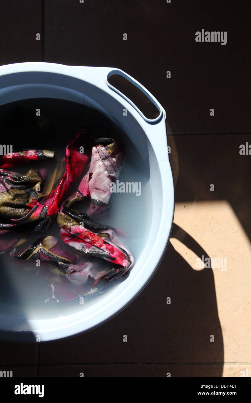 hand washing clothes in a plastic basin bowl Stock Photo Alamy