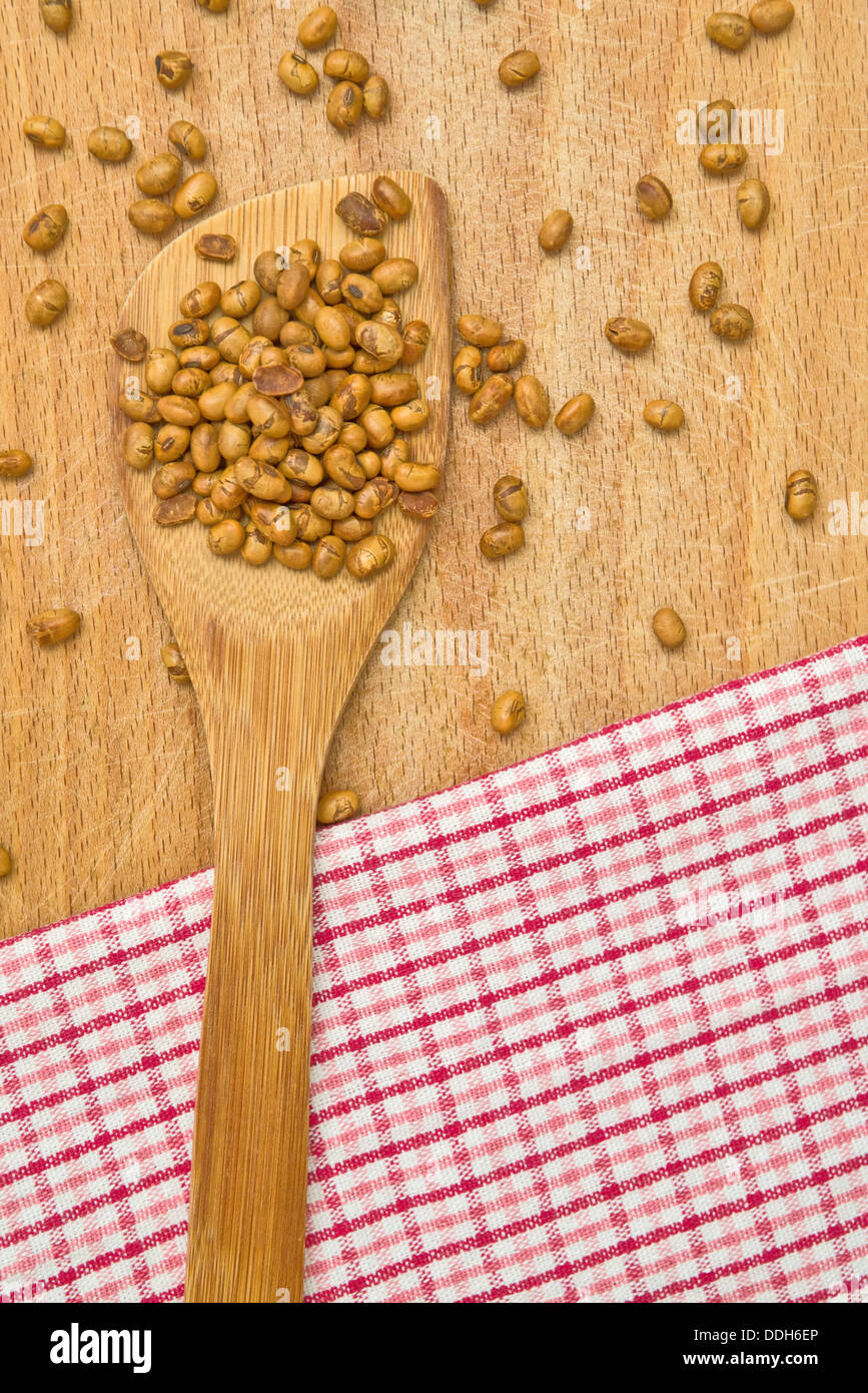 Soy beans on wood kitchen utensil on the table. Stock Photo
