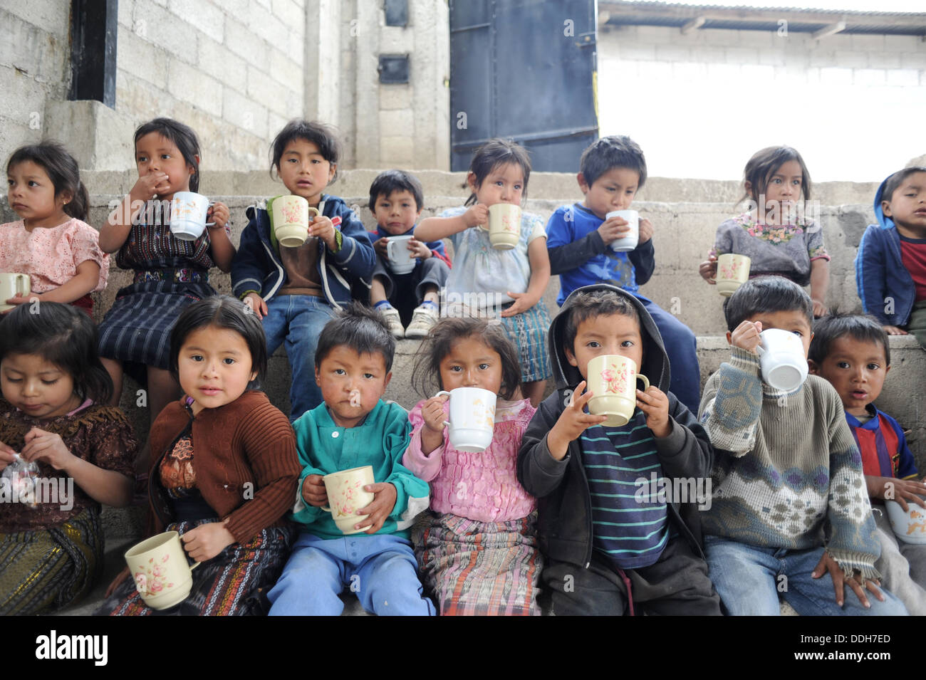 Guatemalan indigenous children drink a cup of atole at preschool in Tierra Linda, Solola, Guatemala. Stock Photo