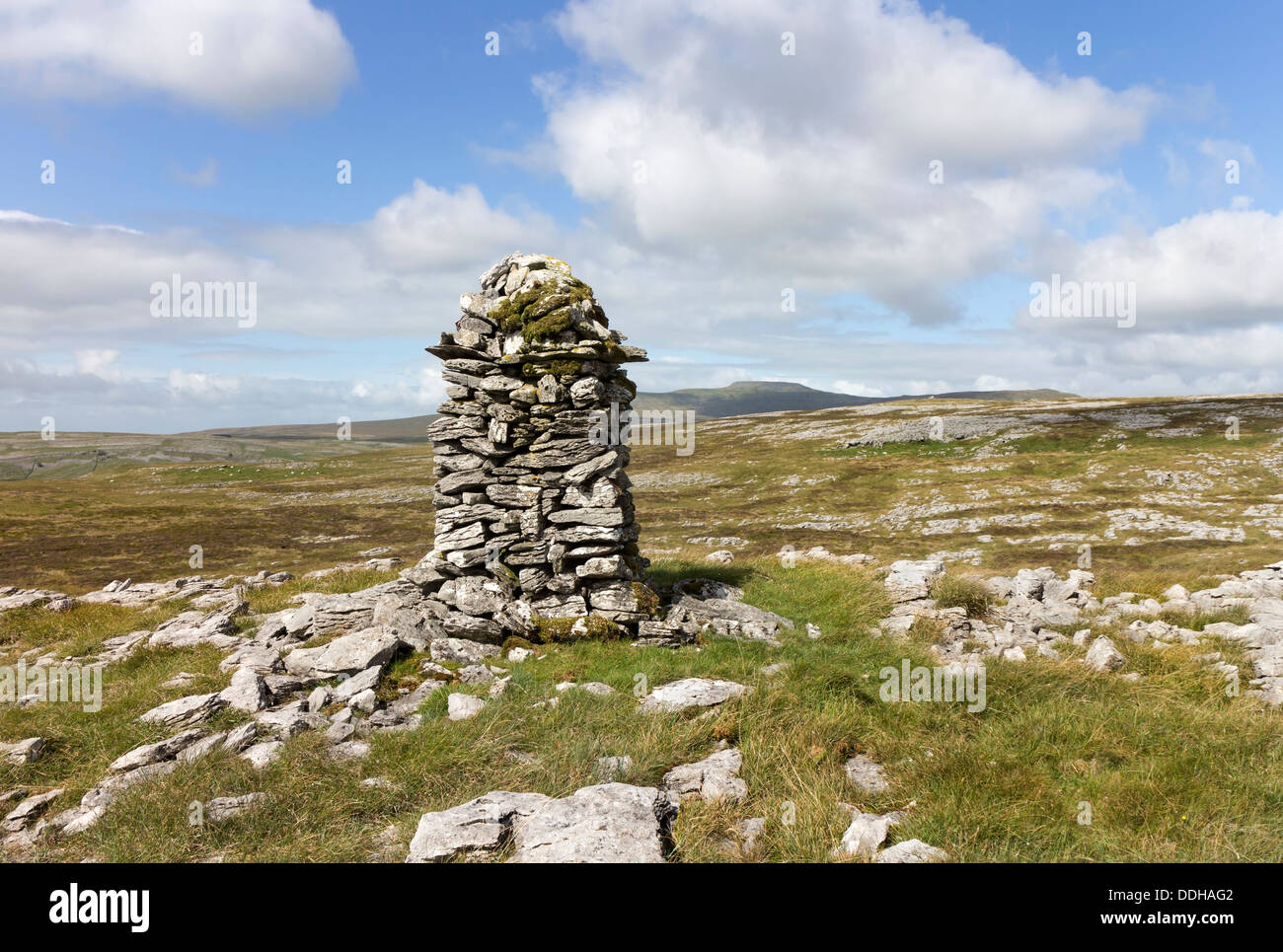 Cairn on Moughton Fell with the Mountain of Ingleborough in the Background Yorkshire Dales UK Stock Photo