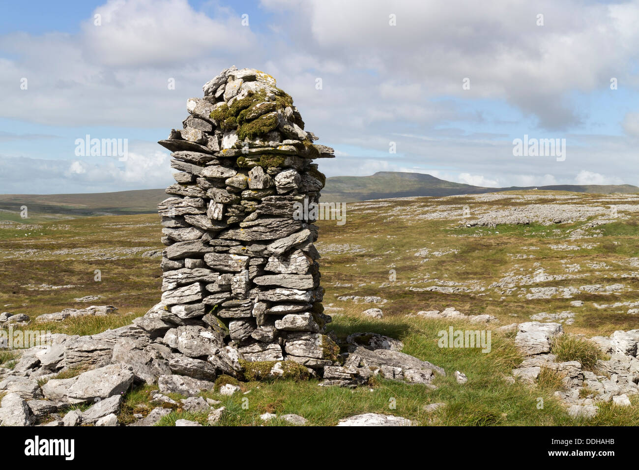 Cairn on Moughton Fell with the Mountain of Ingleborough in the Background Yorkshire Dales UK Stock Photo
