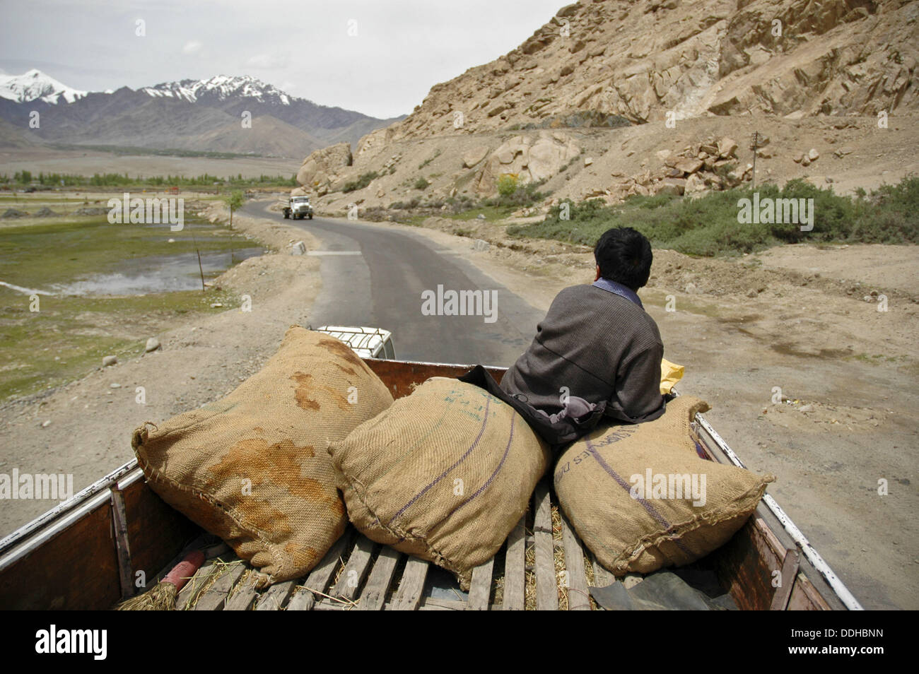 A man riding on the roof of a bus with the luggage Ladakh, India Stock