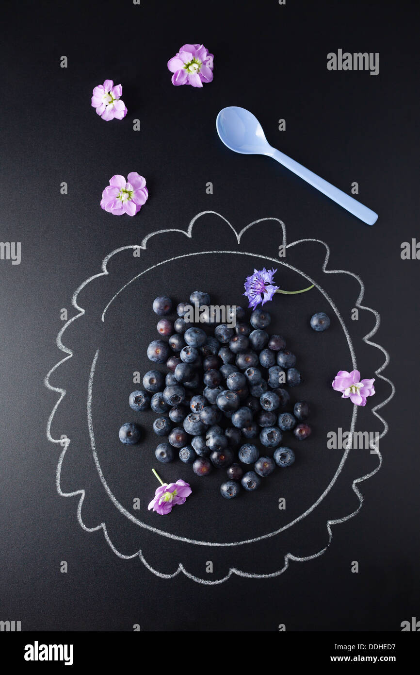 Blueberries on plate painted with chalk, close up Stock Photo