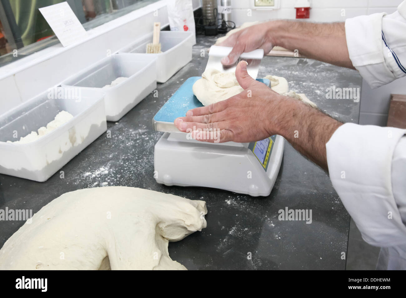 Baker weighs dough for bread Stock Photo Alamy