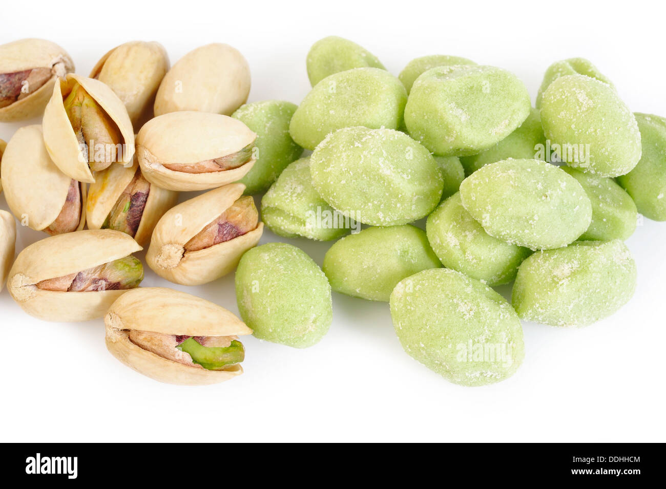 wasabi coated pistachios on white background Stock Photo - Alamy