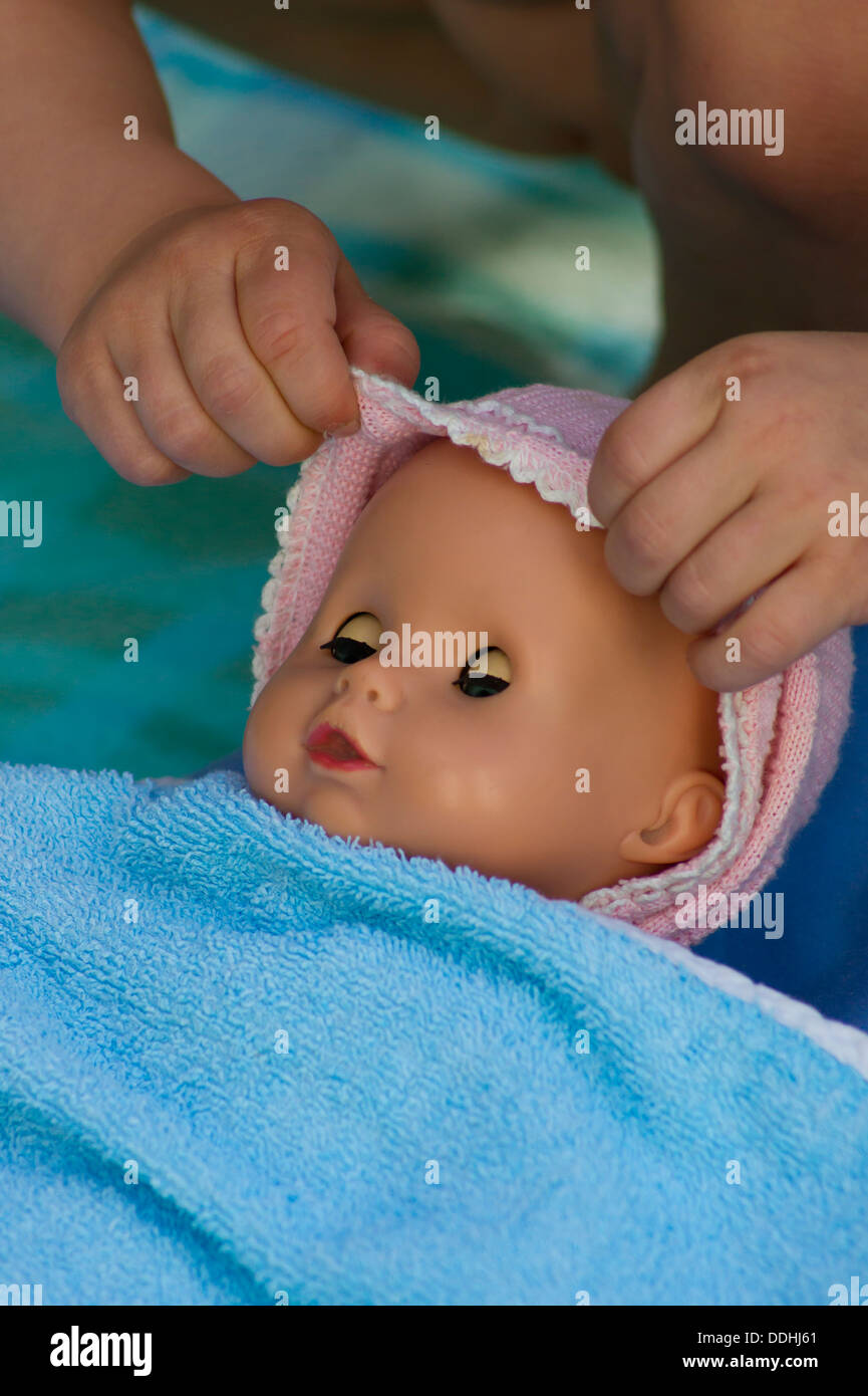 Girl putting doll to sleep hires stock photography and images Alamy