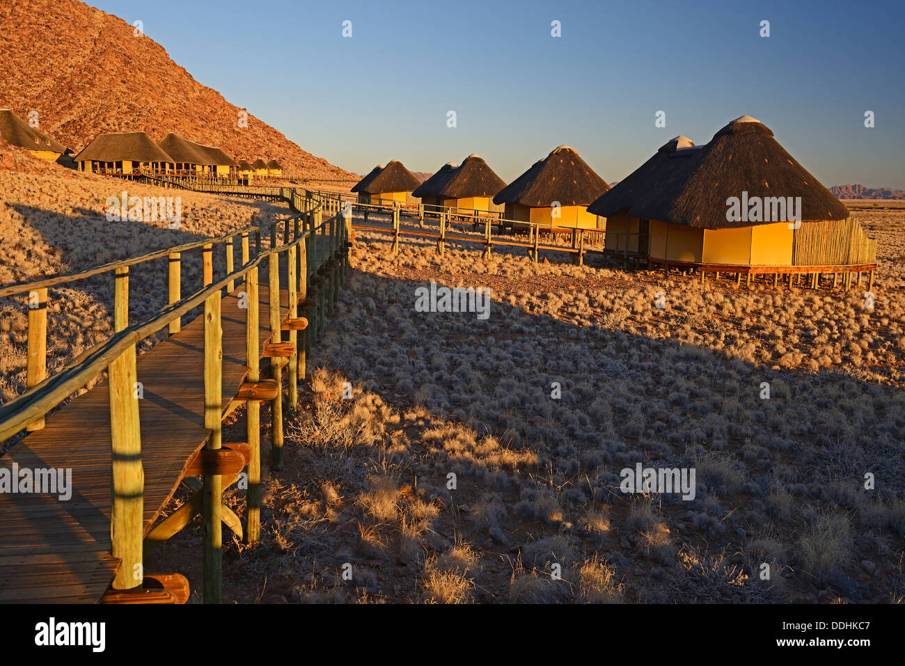 Chalets or cabins of the Sossus Dune Lodge in the evening light Stock Photo